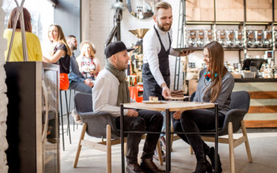 Server In Cafe Serving Chocolate Cake